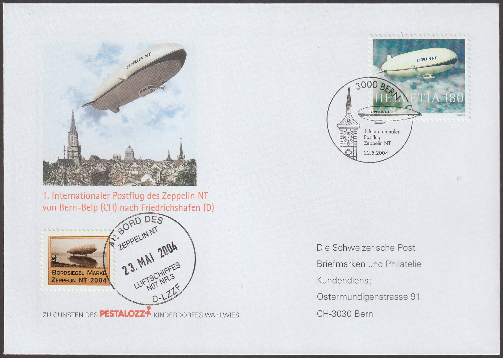 w_26_6_20261001_0094 2004. Svájc, a Zeppelin NT első nemzetközi postarepülésének alkalmi borítékja a Bern-Belp–Friedrichshafen útvonalon, május 22-i berni alkalmi bélyegzéssel, fedélzeti záróbélyeggel és május 23-i fedélzeti bélyegzéssel.